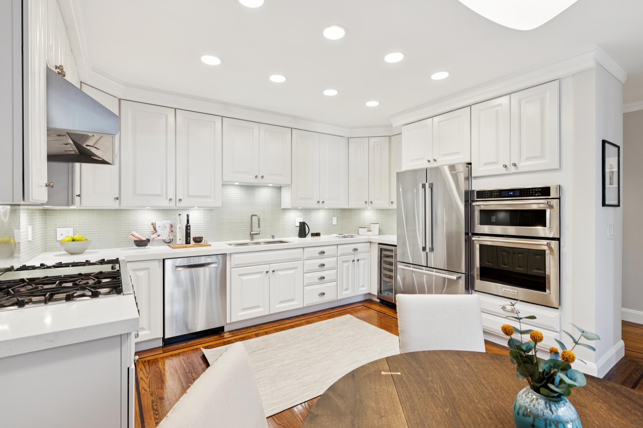 Kitchen with Thermador range, quartz countertops, and wall oven