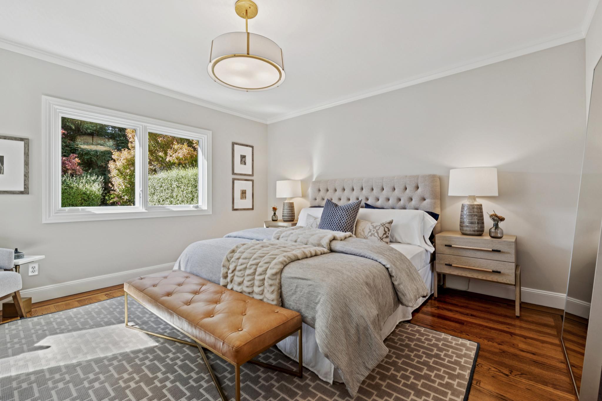 Angled view of the primary bedroom overlooking the private yard