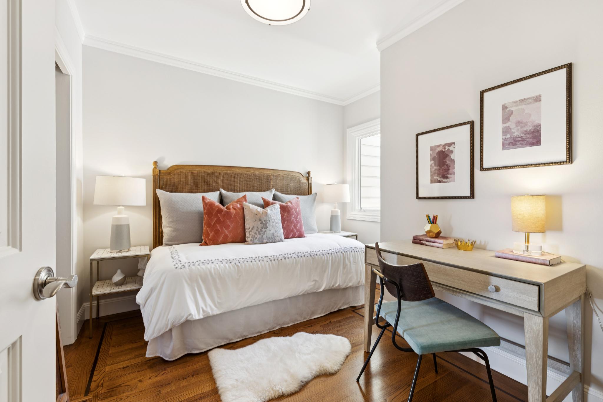 Main-level bedroom with a desk and private balcony access