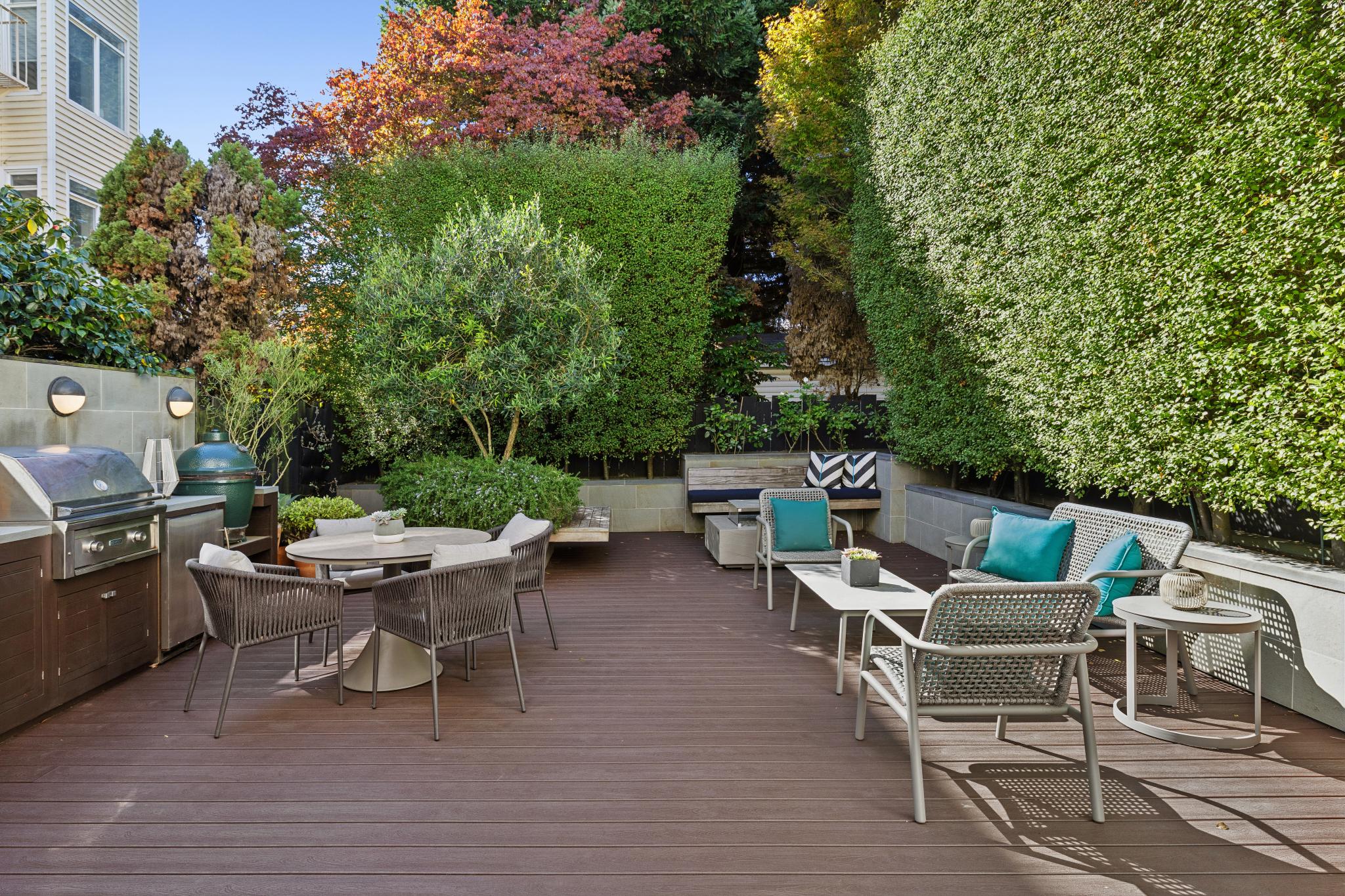 Private landscaped yard with outdoor dining and lounge areas